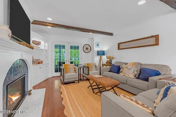 a living room with furniture and a ceiling fan