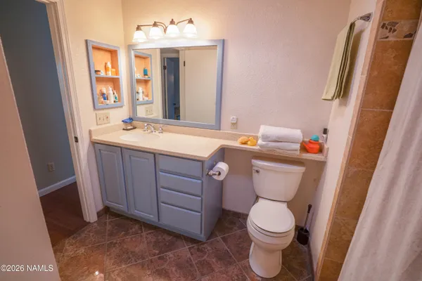 a bathroom with a toilet a sink and a mirror