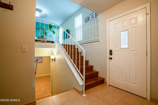 a view of entryway with wooden floor and stairs