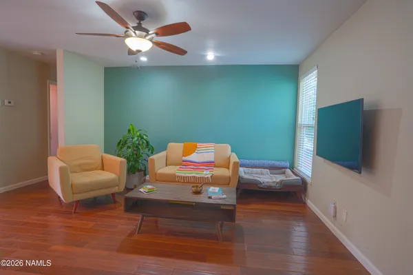 a bedroom with furniture and a wooden floor