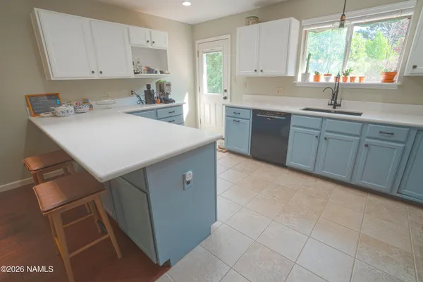 a kitchen with a sink cabinets and window