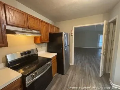 a kitchen with wooden cabinets and a stove top oven