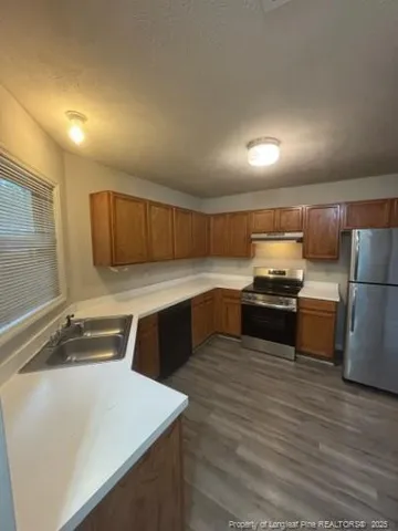 a kitchen with a stove a sink and a refrigerator