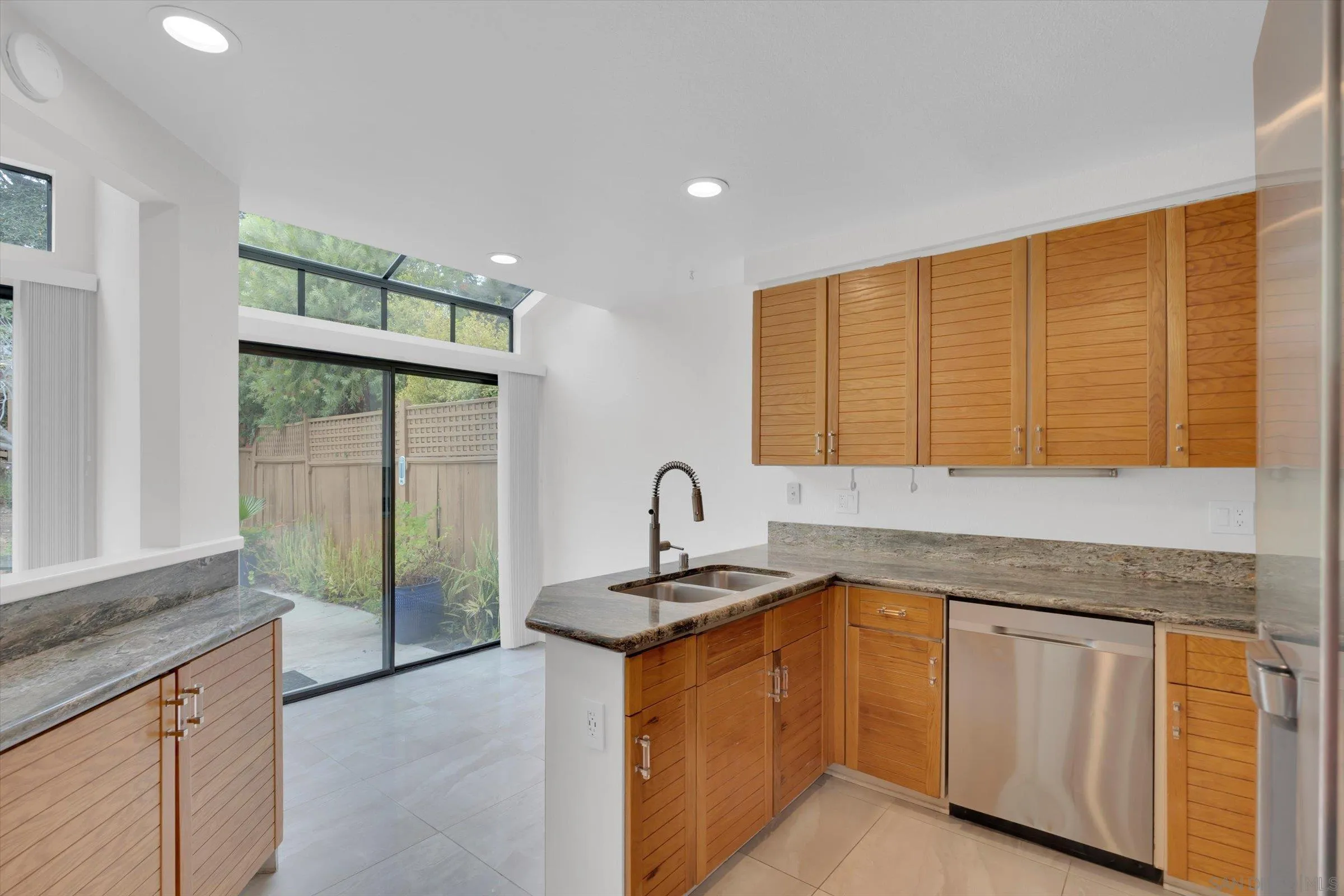 6426 Caminito Listo San Diego, CA 92111 - Photo 14 of 48 a kitchen with granite countertop a sink and a counter top space