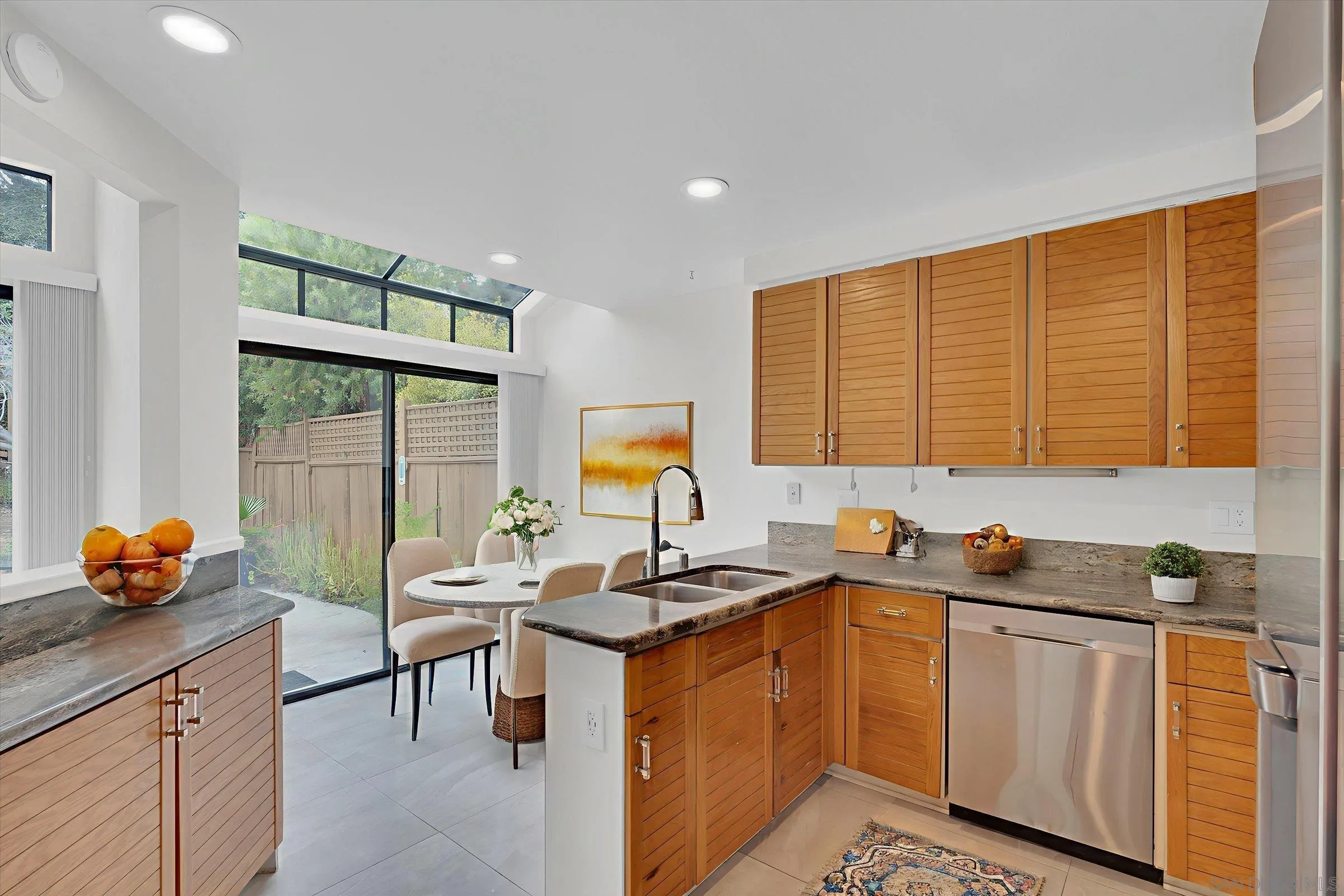 6426 Caminito Listo San Diego, CA 92111 - Photo 15 of 48 a kitchen with granite countertop a sink and a stove