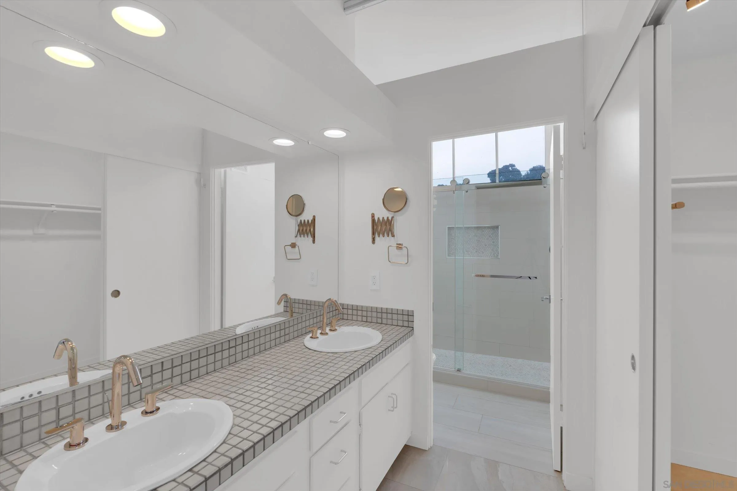 6426 Caminito Listo San Diego, CA 92111 - Photo 34 of 48 a bathroom with a sink double vanity and a mirror