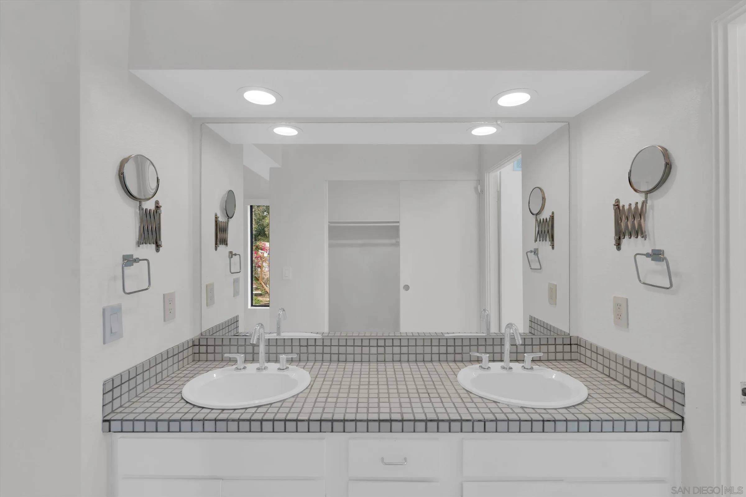 6426 Caminito Listo San Diego, CA 92111 - Photo 36 of 48 a bathroom with a granite countertop sink and a mirror