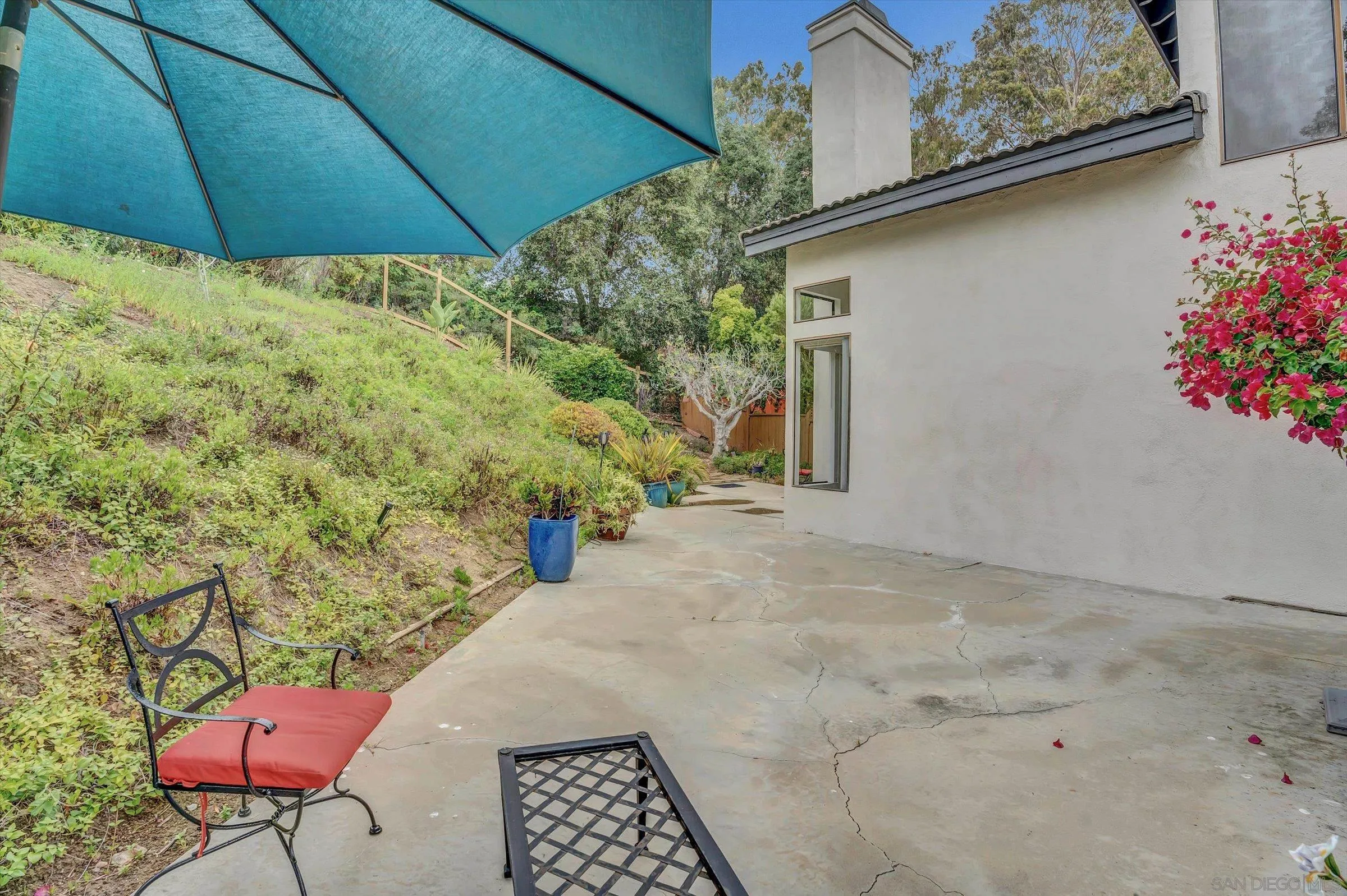 6426 Caminito Listo San Diego, CA 92111 - Photo 40 of 48 a view of a backyard with table and chairs under an umbrella