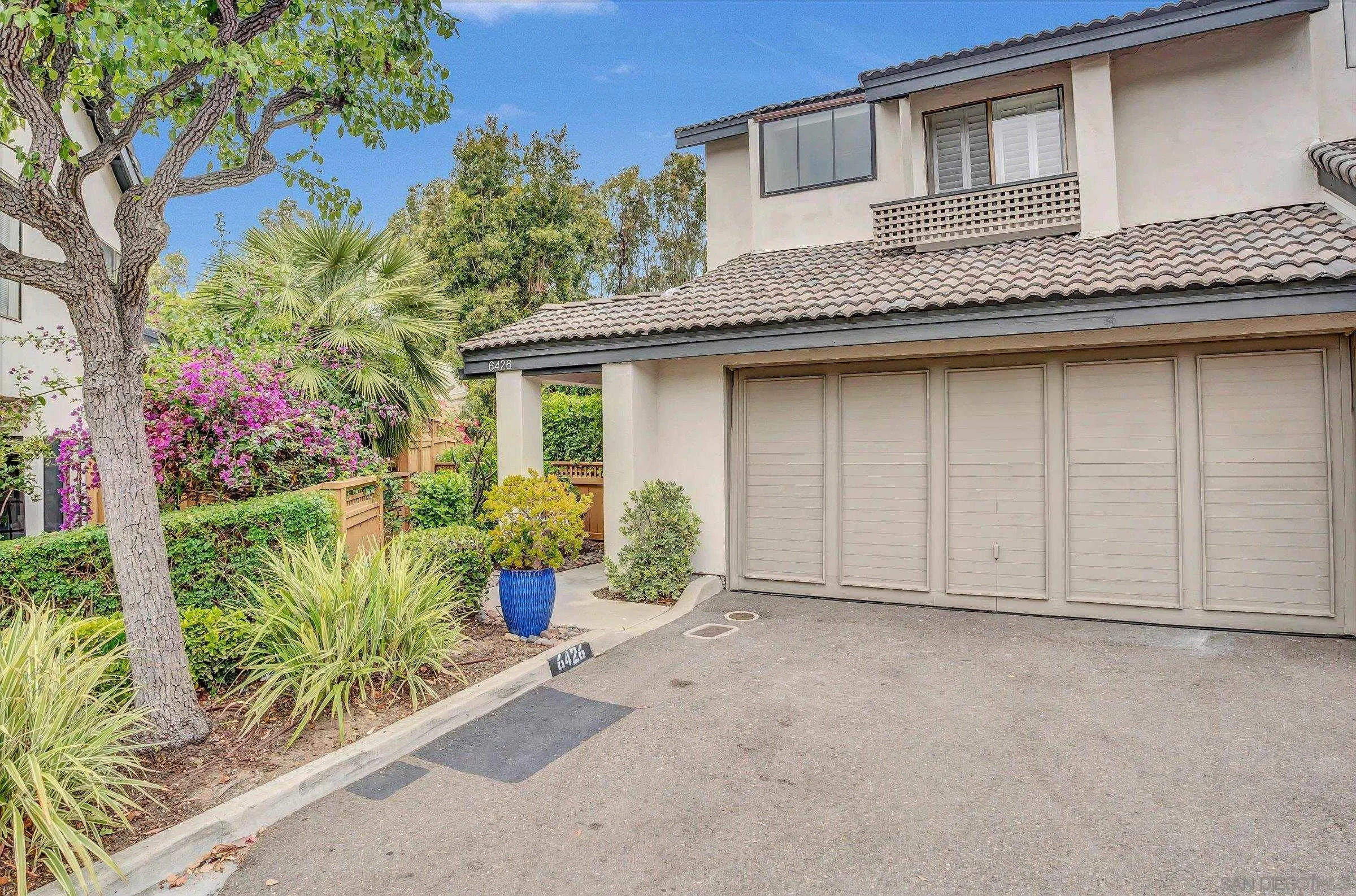 6426 Caminito Listo San Diego, CA 92111 - Photo 5 of 48 a front view of a house with a garden