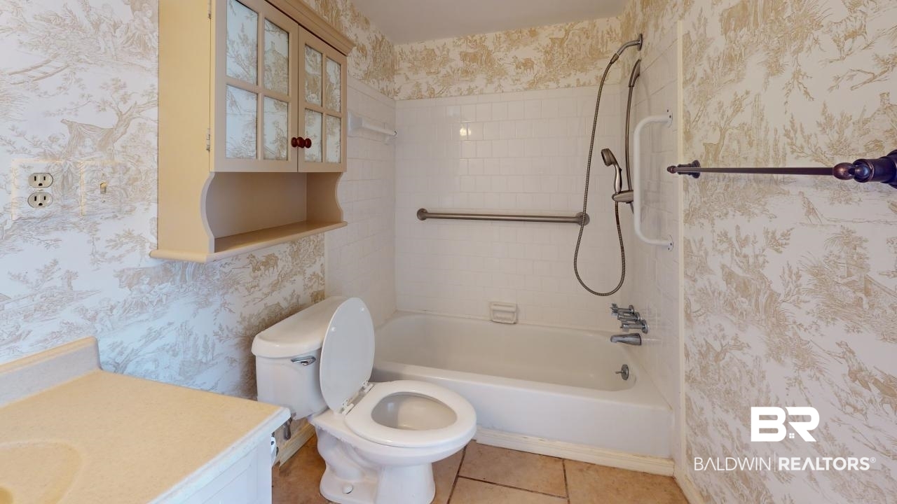 4009 Old Shell Road, Unit C13 Mobile, AL 36608 - Photo 17 of 32 Full bath with vanity, shower / tub combination, wallpapered walls, toilet, and tile patterned floors