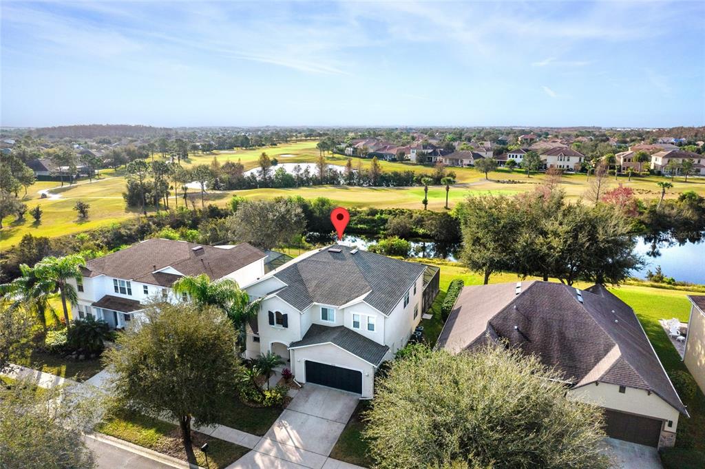 an aerial view of residential houses with outdoor space