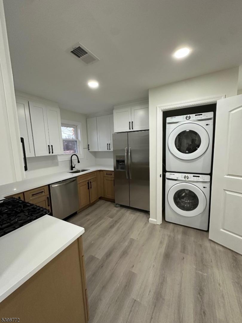 112 Fairview Avenue, Unit 2 Middlesex, NJ 08846 - Photo 13 of 29 a kitchen with a refrigerator a sink and wooden cabinets
