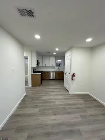 a view of kitchen and a refrigerator in a room