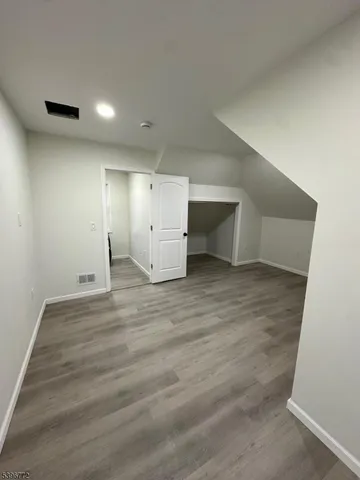 a view of a room with wooden floor and cabinet