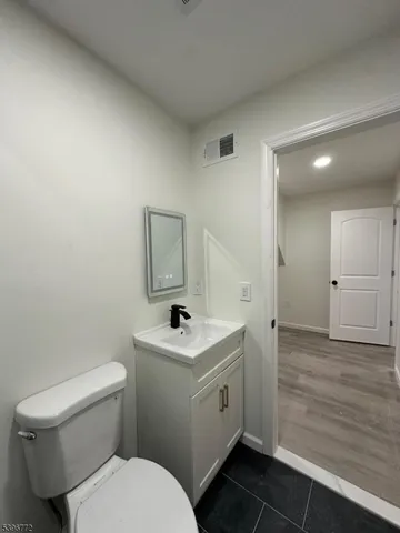 an empty room with wooden floor and window