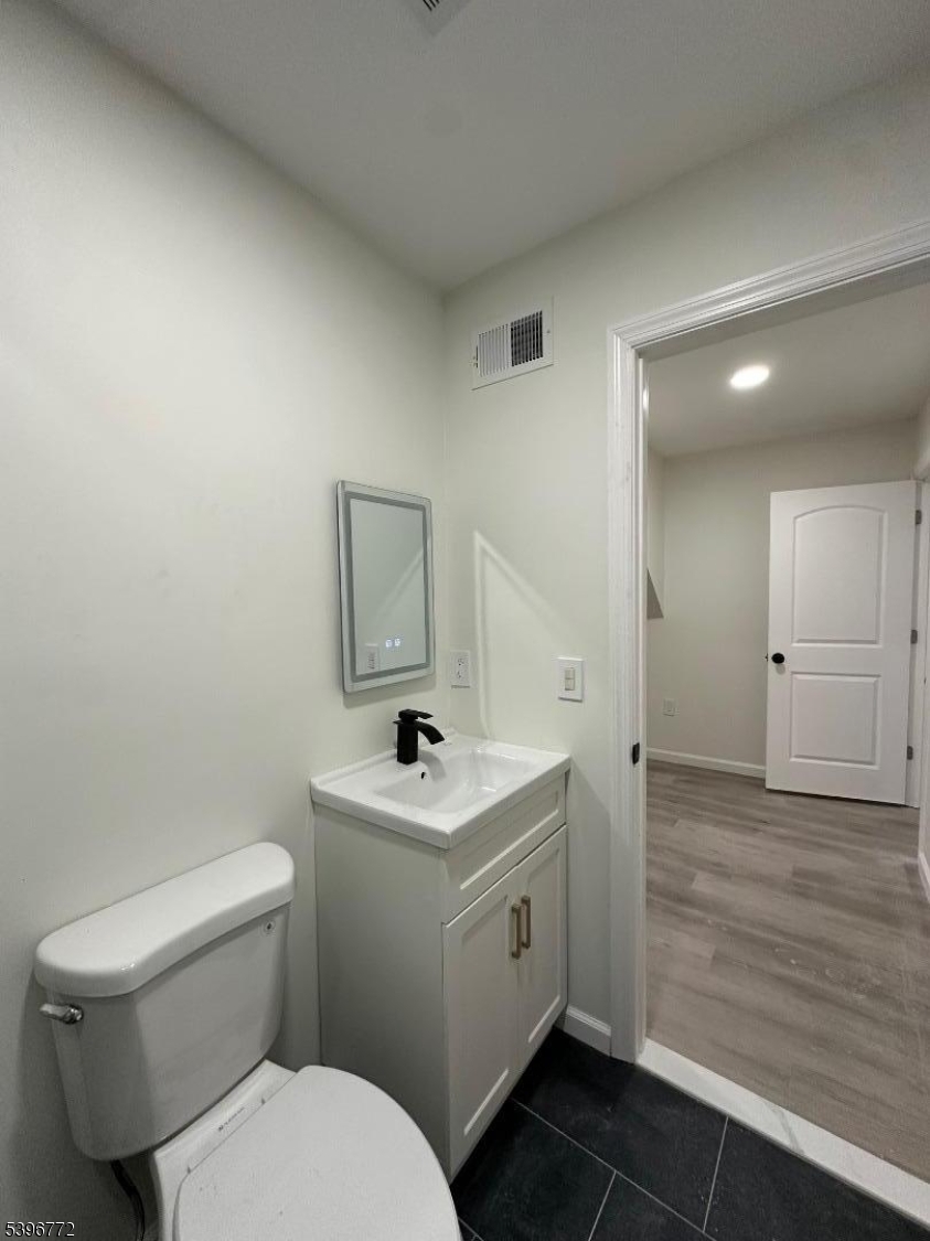 112 Fairview Avenue, Unit 2 Middlesex, NJ 08846 - Photo 25 of 29 a bathroom with a toilet sink and mirror