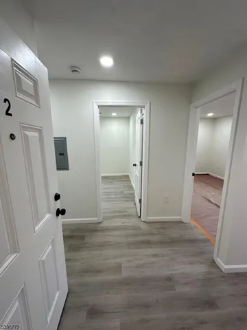 a view of a hallway with wooden floor