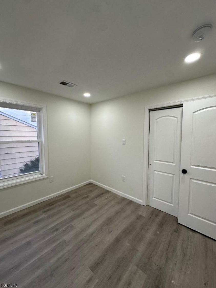112 Fairview Avenue, Unit 2 Middlesex, NJ 08846 - Photo 7 of 29 a view of an empty room with wooden floor and a window