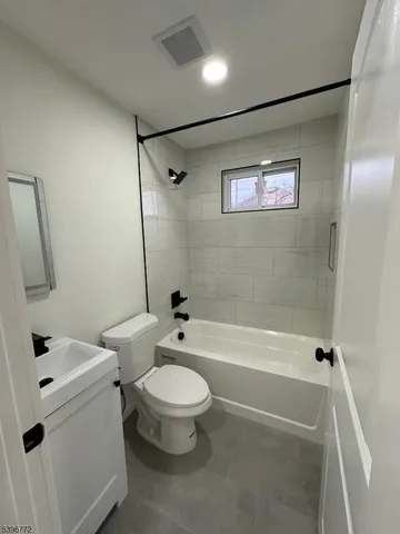 a bathroom with a toilet and a bath tub