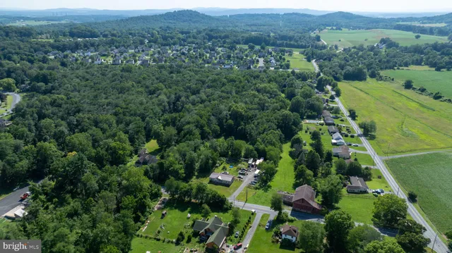 an aerial view of a forest with houses