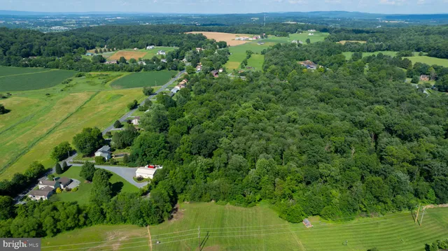 an aerial view of a houses with a yard