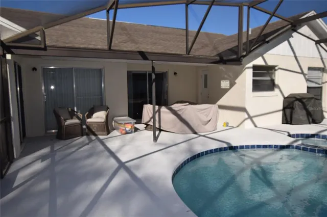 a view of a patio with table and chairs
