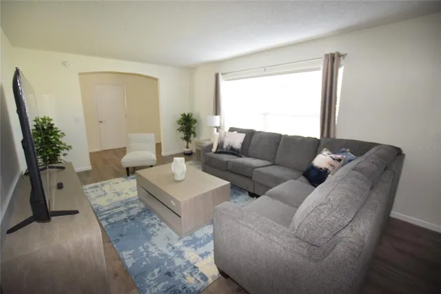 a living room with furniture and a large window