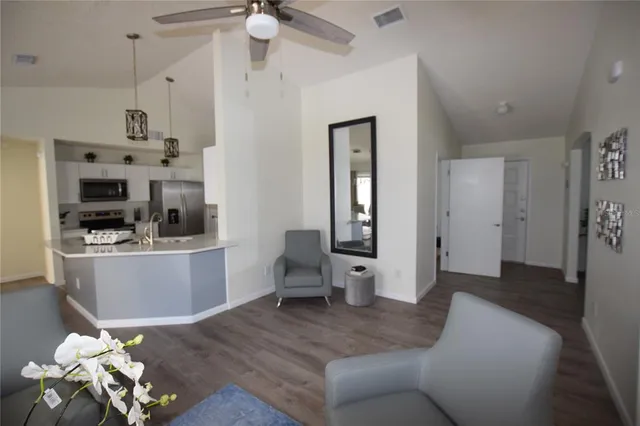 a living room with kitchen island furniture and a kitchen view