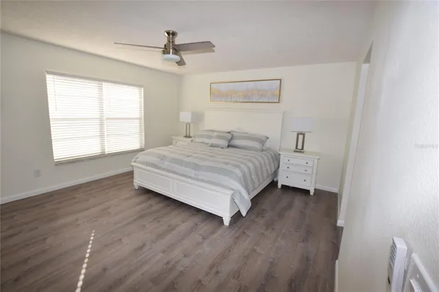 a spacious bedroom with a bed and a window