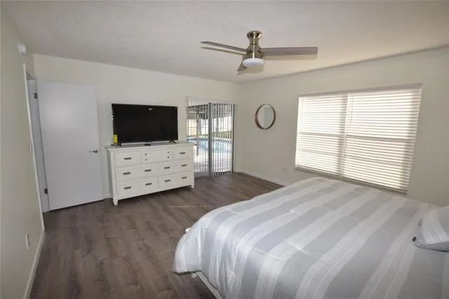 a bedroom with furniture and a flat screen tv