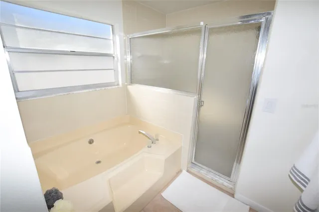 a bathroom with a bathtub and a shower