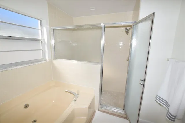 a bathroom with a bathtub and a shower