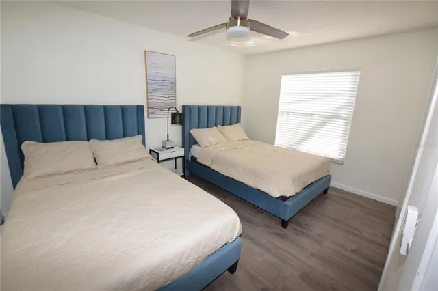 a bedroom with two beds and a chandelier