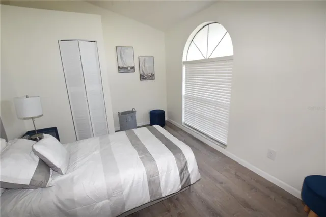 a bedroom with a bed and a window