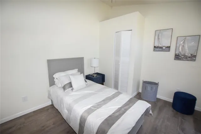 a bedroom with a bed and a chair