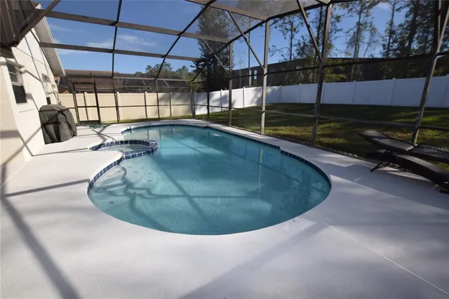 a view of a swimming pool with a patio