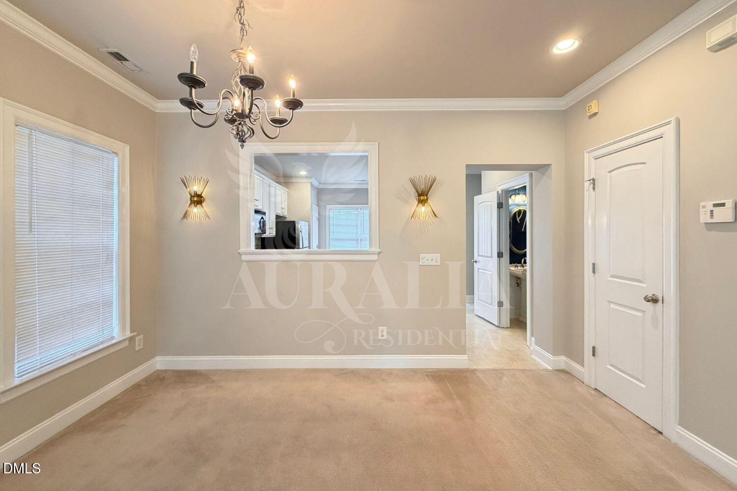 7754 ACC Boulevard Raleigh, NC 27617 - Photo 6 of 41 en empty room with wooden floor and mirror