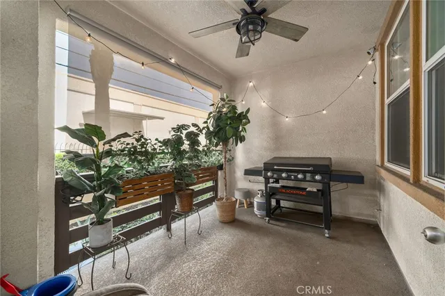a view of a livingroom with furniture and a ceiling fan