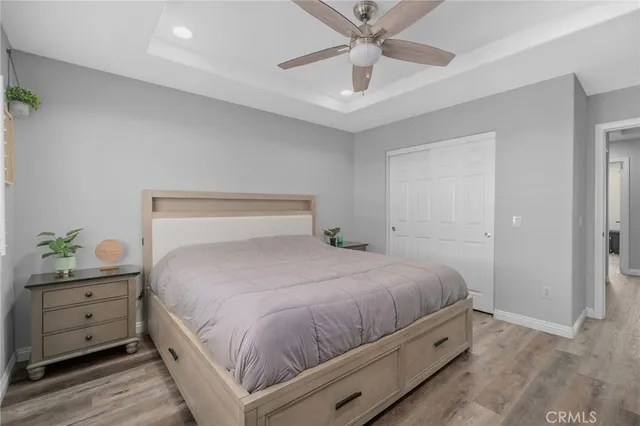 a bedroom with a bed and a potted plant