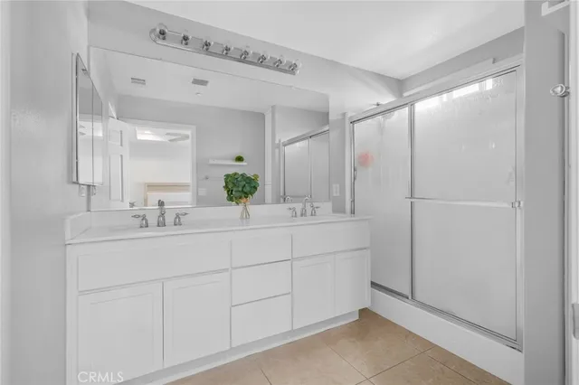 a bathroom with a double vanity sink and mirror
