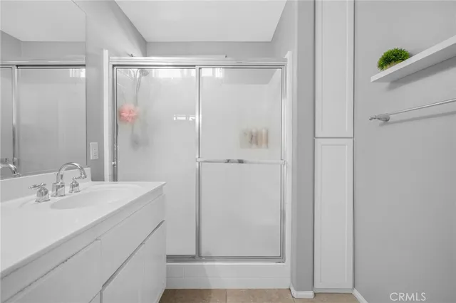 a bathroom with a shower and a sink