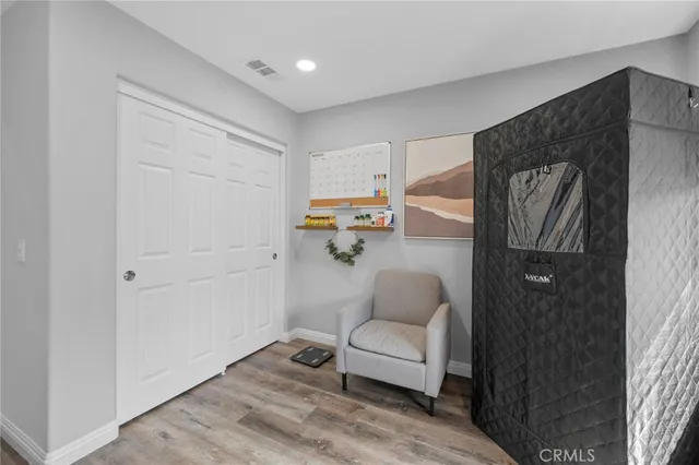 a hallway with a couch and a dresser with wooden floor
