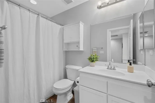 a bathroom with a sink toilet and a mirror