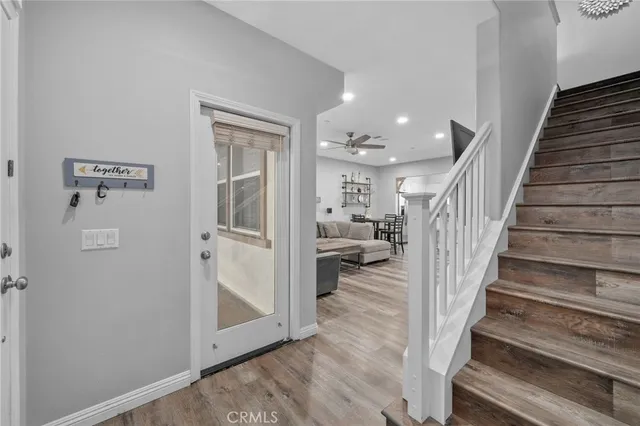a view of a hallway with wooden floor and entryway