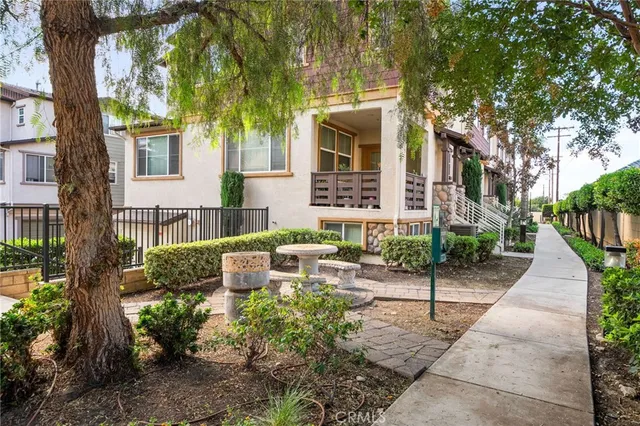 a front view of a house with garden and plants
