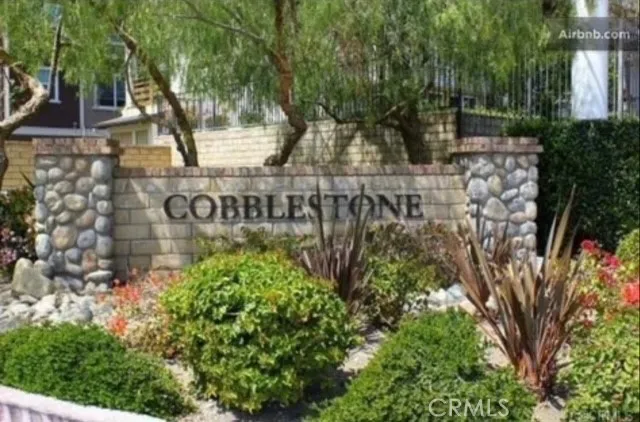 a sign that is sitting in front of flowers