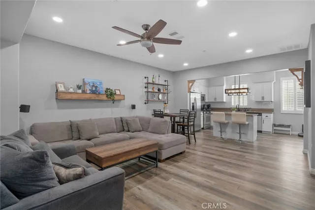 a living room with furniture and kitchen view
