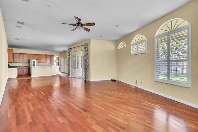 a view of a livingroom with a window and wooden floor