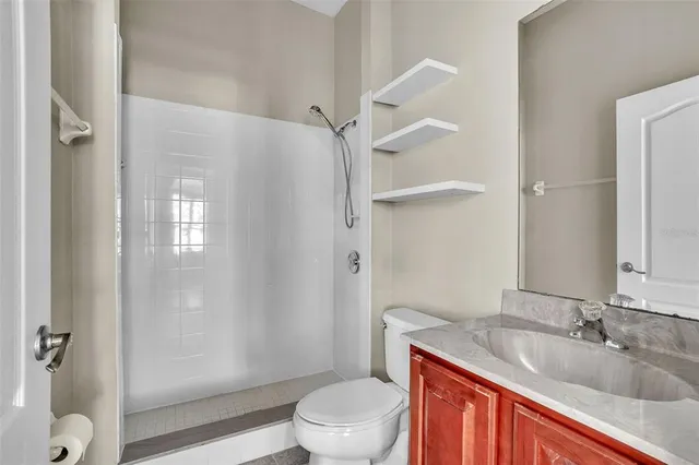 a bathroom with a sink toilet and shower