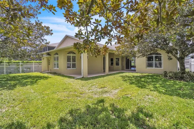 a view of a room with wooden floor and chandelier
